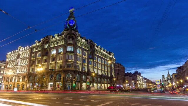 Corner view of Singer House in Saint Petersburg timelapse at night with traffic. People gather near the iconic building located at the end of Nevsky Prospekt and the Griboyedov Canal