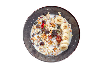 granola bowl milk, dried fruit and fresh banana tasty breakfast healthy meal food snack on the table copy space food background rustic top view 