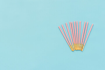 Pocky biscuits isolated on blue background, after some edits.