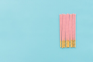 Pocky biscuits isolated on blue background, after some edits.