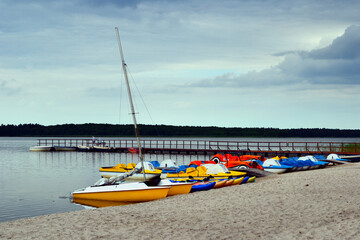 Fototapeta premium Sarbsko lake, a coastal lake on the Slowinski Coast, Poland. Water equipment rental - boats, kayaks, pedal boats