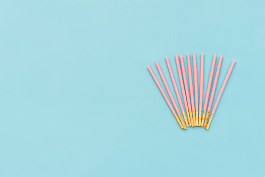 Pocky biscuits isolated on blue background, after some edits.