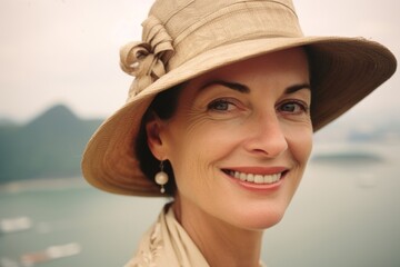 Close-up portrait photography of a satisfied mature woman wearing a sophisticated pillbox hat near the christ the redeemer in rio de janeiro brazil. With generative AI technology