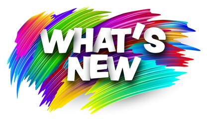 What's new paper word sign with colorful spectrum paint brush strokes over white.