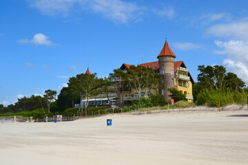 A view of historic hotel building on sand dune, Leba beach, Baltic Sea, Poland. Castle on the beach. Beautiful sunny weather