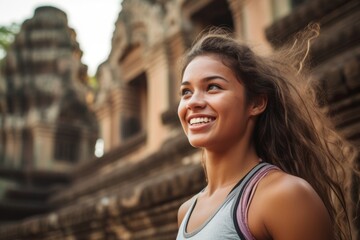 Fototapeta premium Close-up portrait photography of a satisfied girl in her 20s wearing a high-performance basketball jersey at the angkor wat in siem reap cambodia. With generative AI technology
