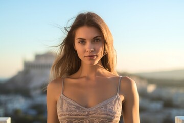 Fototapeta na wymiar Close-up portrait photography of a glad girl in her 30s wearing a lace bralette in front of the acropolis in athens greece. With generative AI technology