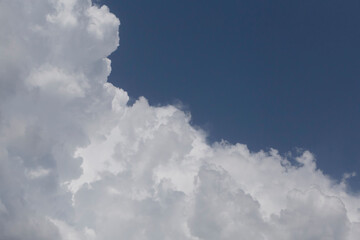 white fluffy cloud against blue sky