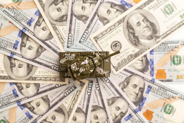 Tank on dollar banknotes. The concept of war costs, military spending, economic crisis