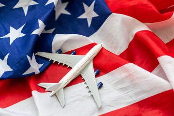 Toy plane with american flag on grey background. Top view