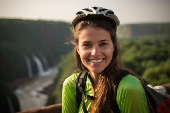 Medium shot portrait photography of a happy girl in her 20s wearing a padded cycling jersey at the iguazu falls argentina-brazil border. With generative AI technology