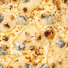 Close-up of pizza filling and texture, blue cheese, walnuts and pears on top