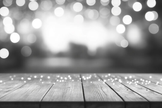Wooden table with bokeh lights on background. Black and white