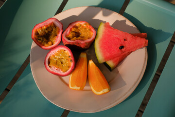 Mix summer fruit passion fruit watermelon and orange on a plate