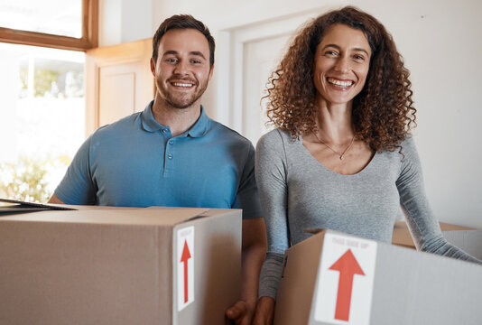 Moving, new home or portrait of happy couple with boxes in real estate, property or rental apartment. Woman, proud man or excited people carrying or lifting package in a house on loan with smile