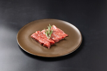 Rare Sliced Wagyu beef with marbled texture. Japanese and korean rare beef for grilled on black...
