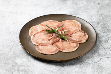 sliced beef tongue. Japanese and korean rare beef for grilled on black plate food isolated on black banner background
