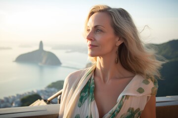 Fototapeta na wymiar Photography in the style of pensive portraiture of a cheerful mature woman wearing a trendy off-shoulder blouse at the christ the redeemer in rio de janeiro brazil. With generative AI technology