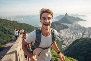 Naklejka premium Environmental portrait photography of a joyful boy in his 20s wearing a lightweight running vest at the christ the redeemer in rio de janeiro brazil. With generative AI technology