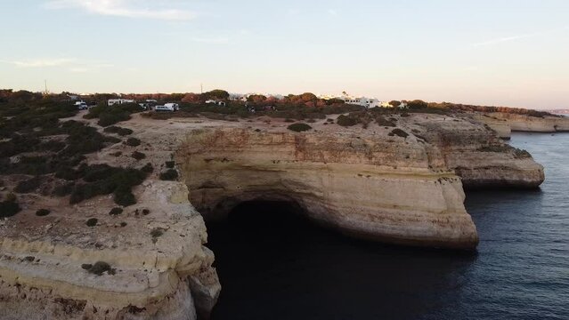 Aerial Landscape View of the Sea Shoreline and City up on the Rocks. Still drone video of the ocean off the coast.
