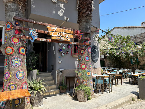 Cunda, Turkey - 22.08.2023. Street view in Cunda Island in Ayvalik, is an old town by the Aegean Sea. Colorful cafes and restaurants along the streets of Cunda, Ayvalik, Balikesir. Zayka restaurant