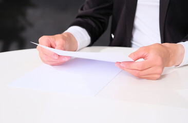 Businesswoman analyzes / reads documents before a deal