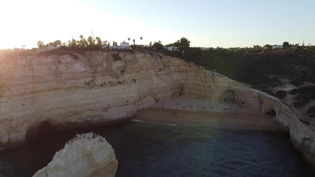 Inward Aerial Drone shot towards Beach and People enjoying Life. Quick into a sandy sunny beach.