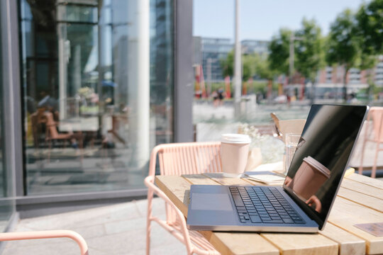 Urban Cafe Workspace with Laptop and Refreshing Drink Ready for Productivity