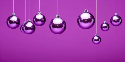 Purple christmas baubles hanging on strings on purple background - Powered by Adobe