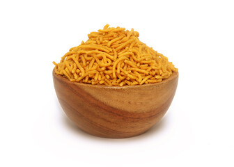 Close up of Spicy Aloo Bhujia on a wooden bowl, made with Red chili, Potatoes, and Chickpeas. Indian spicy snacks (Namkeen),  side view 