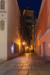 View of an old narrow medieval street near the long market at night, Gdansk, Poland.