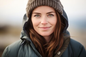 Close-up portrait photography of a blissful girl in her 40s wearing a quilted insulated jacket at the blue lagoon in reykjavik iceland. With generative AI technology - obrazy, fototapety, plakaty