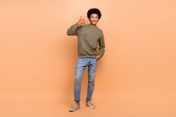 Fototapeta premium Full size photo of cheerful satisfied guy with afro hairstyle wear khaki shirt showing like good job isolated on beige color background