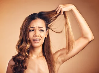 Foto op Canvas Hair, problem and sad woman with damage and frustrated from salon treatment and Brazilian fail. Studio, brown background and model with crisis from split ends and upset of bad and messy haircut © Sharne/peopleimages.com