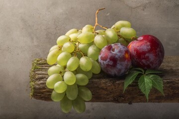 still life with plums and grapes