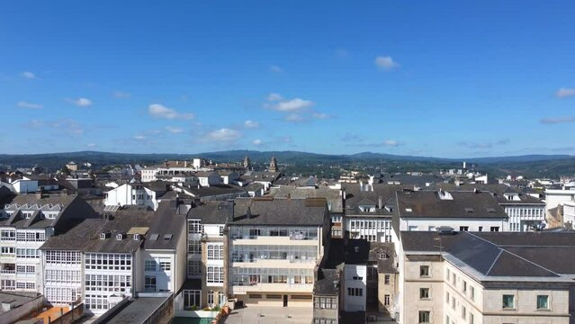 Aerial View of Lugo City and Surrounding Mountains - 4k DJI Mini 2 - City buildings goins backwards