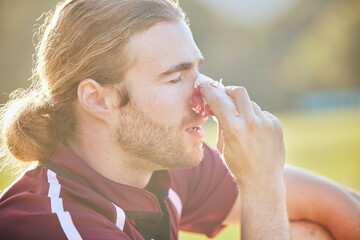 Nose bleed, man closeup and sports injury closeup on field with emergency, health accident and...