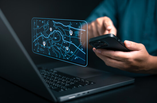 Businessman using smartphone and computer to search map with geolocation points. Synchronize GPS, Mark destination trip app and find business places by online map system, Exploring target location. - Powered by Adobe