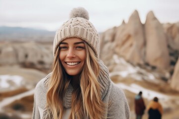 Medium shot portrait photography of a cheerful girl in her 20s wearing a warm wool sweater at the cappadocia in nevsehir province turkey. With generative AI technology - obrazy, fototapety, plakaty