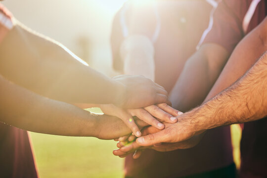 Hands, sports and a rugby team in huddle together for a game or goal of competition in a stadium closeup. Fitness, teamwork and flare with an athlete group standing in circle for solidarity or unity