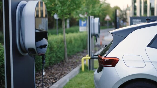 Electric car station. Charge station for electric cars. Electric car charger. Electric cars at a charging station. Electric, zero pollution cars on green energy concept on modern city parking lot