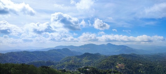Fototapeta na wymiar landscape with clouds mountain blue sky green forest