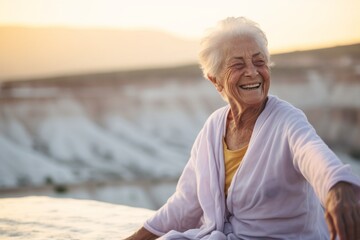 Lifestyle portrait photography of a happy old woman wearing a comfortable yoga top at the pamukkale in denizli turkey. With generative AI technology