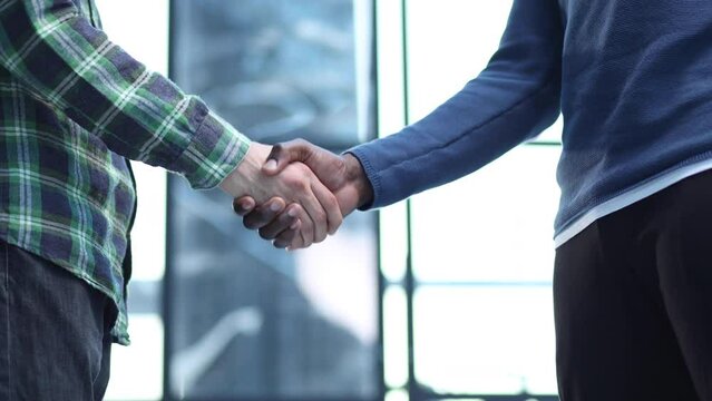 african black businessman handshaking white partner congratulating with successful dea