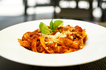 italian bolognese pasta with tomatoes, meat, basil and parmesan