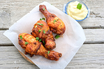 Crispy  deep fried home made    chicken   legs  Breaded  with  almond flour chicken  breast fillets  with chilly peppers and fresh   basil on wooden rustic background. Ketogenic diet food