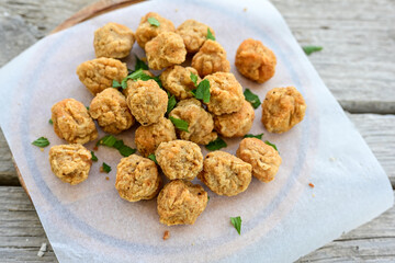 Crispy  deep fried   chicken  nuggets . Breaded  with Cornflakes Breast fillets  with chilly peppers and fresh   basil on wooden rustic background