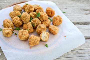 Crispy  deep fried   chicken  nuggets . Breaded  with Cornflakes Breast fillets  with chilly peppers and fresh   basil on wooden rustic background