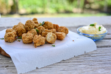 Crispy  deep fried   chicken  nuggets . Breaded  with Cornflakes Breast fillets  with chilly peppers and fresh   basil on wooden rustic background