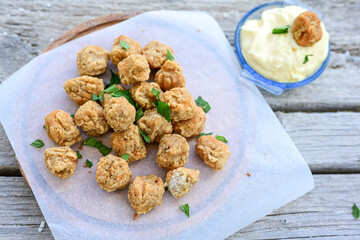 Crispy  deep fried   chicken  nuggets . Breaded  with Cornflakes Breast fillets  with chilly peppers and fresh   basil on wooden rustic background